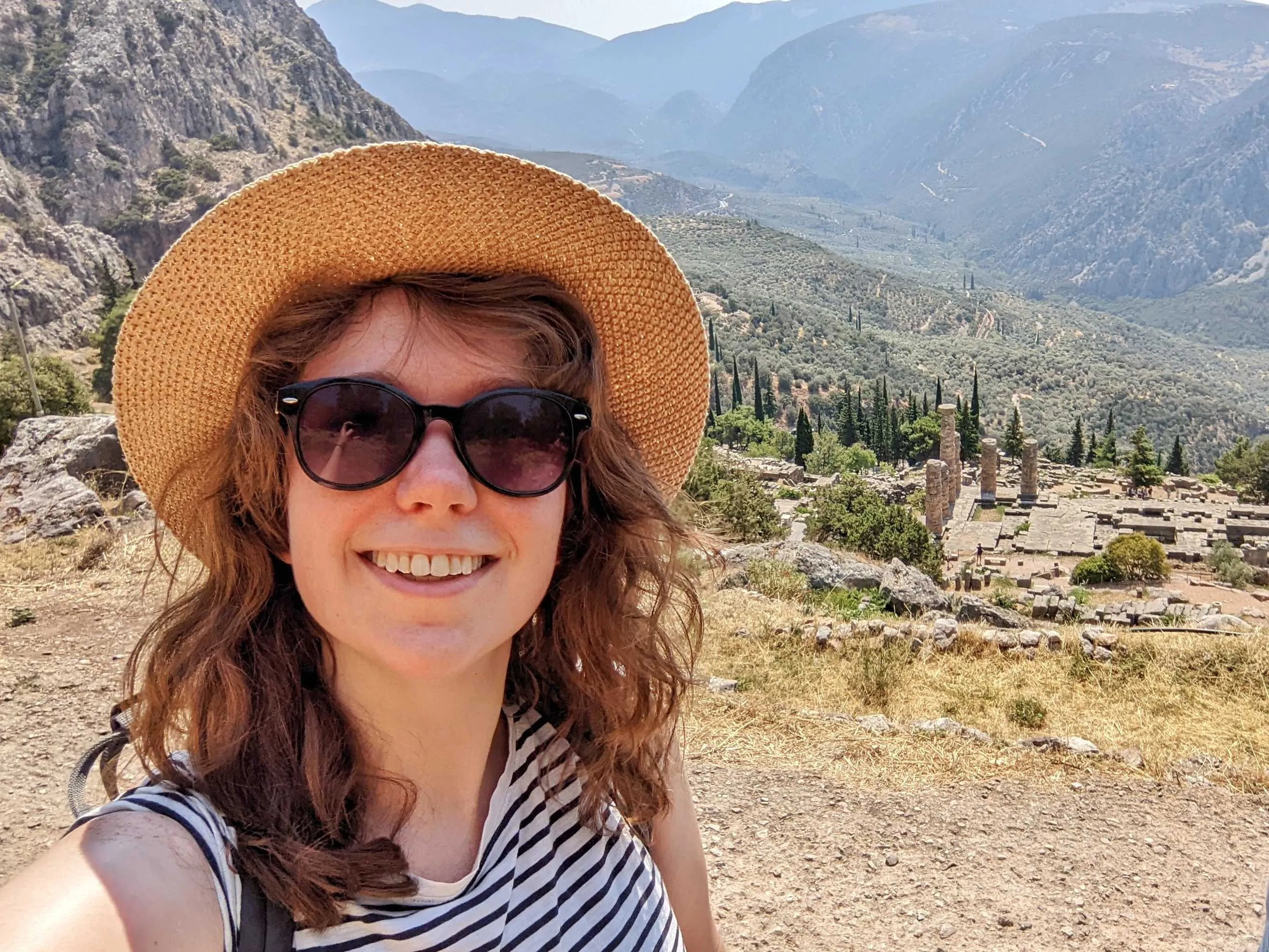 A selfie of me in Greece! I have a sunhat and sunglasses on.