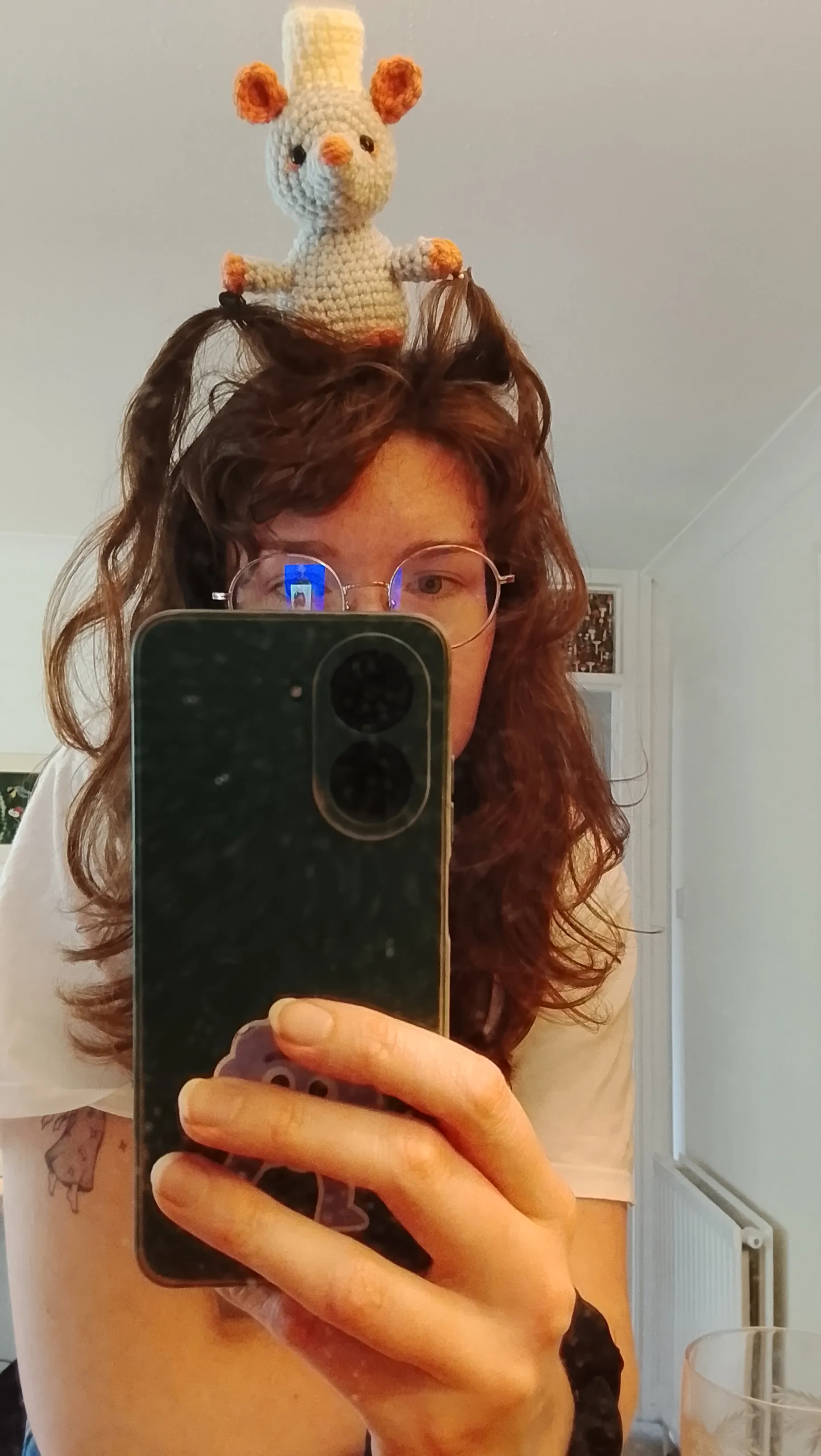 The crochet rat sits on my head.