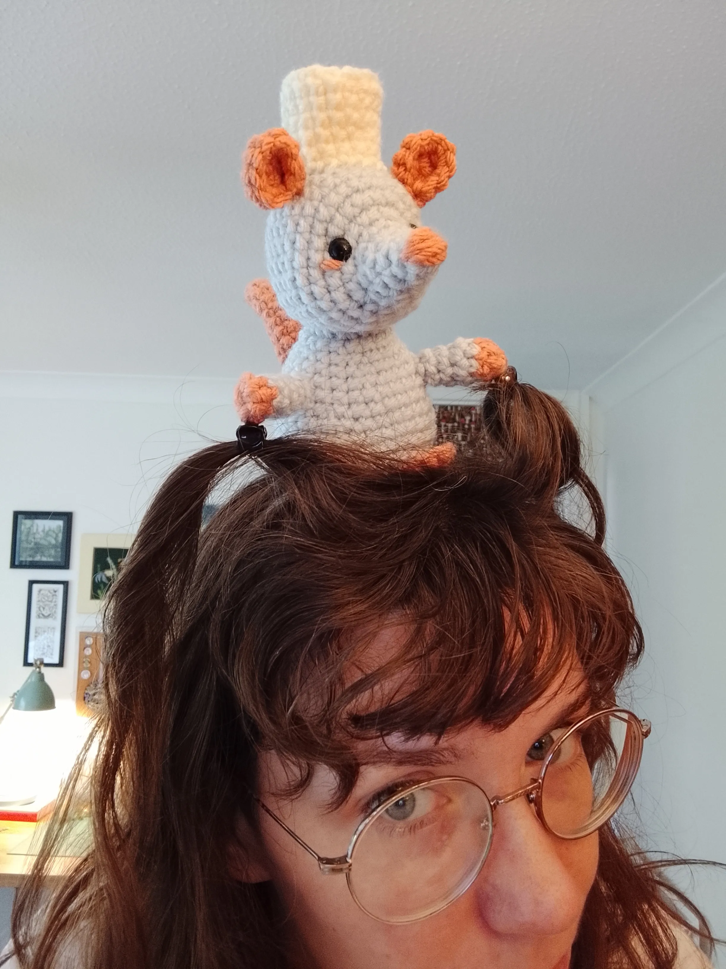 The crochet rat sits on my head.